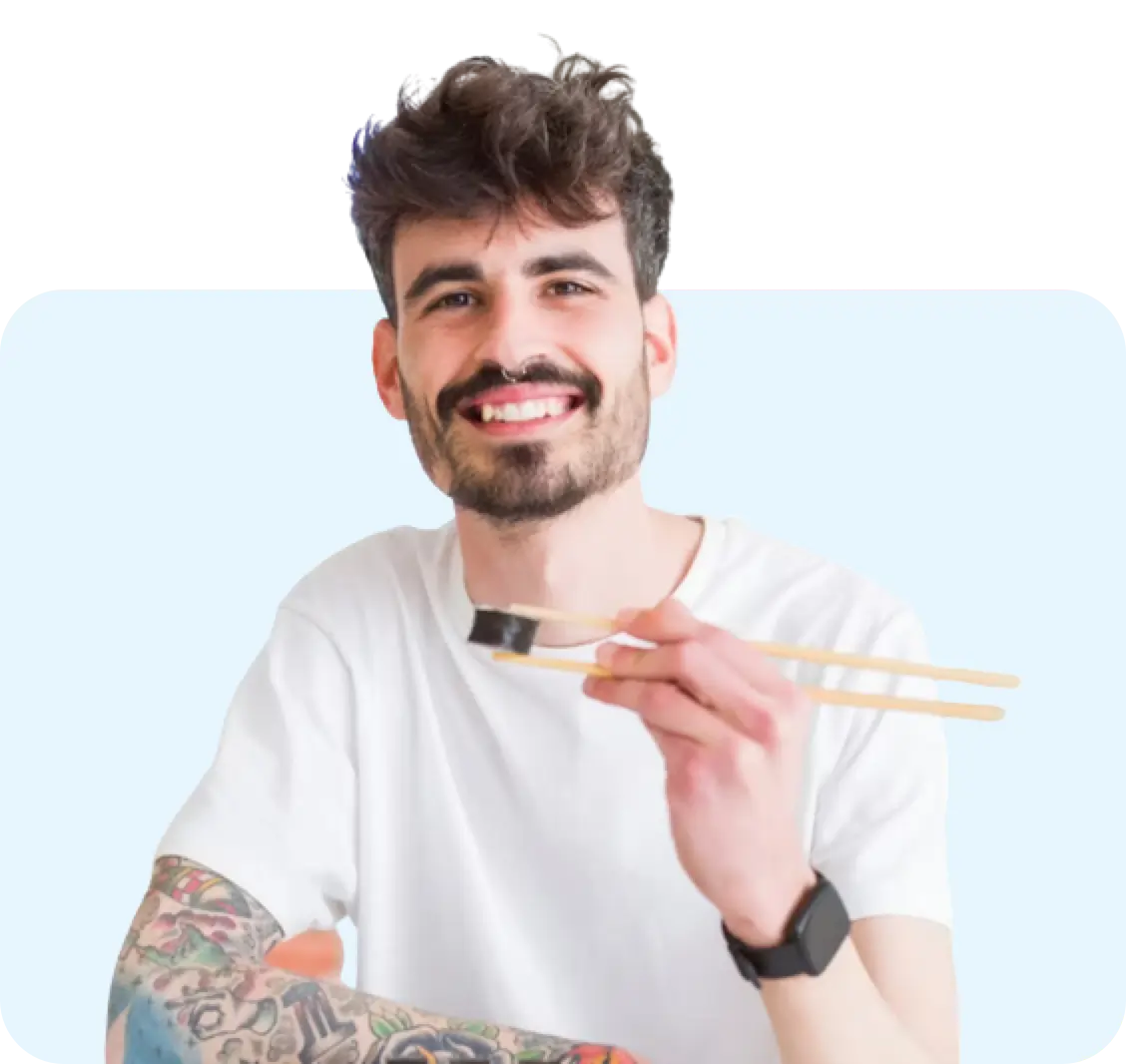 Man eating sushi with sticks